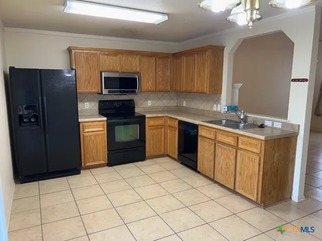 a kitchen with stainless steel appliances a sink and a refrigerator