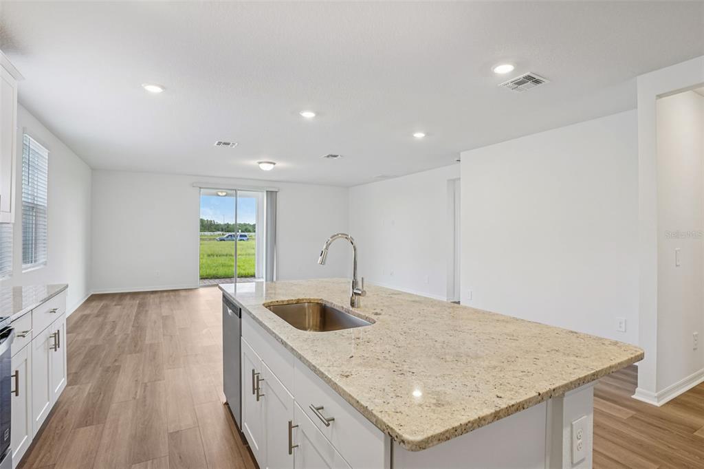 4519 Windy Oak Way St. Cloud, FL 34772 - Photo 14 of 40 a kitchen with a sink a counter top space and cabinets