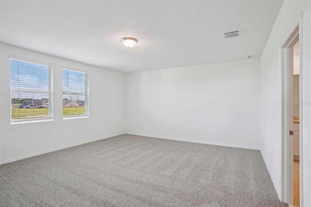 4519 Windy Oak Way St. Cloud, FL 34772 - Photo 15 of 40 an empty room with windows