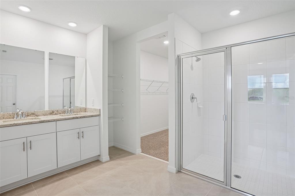 4519 Windy Oak Way St. Cloud, FL 34772 - Photo 18 of 40 a bathroom with a double vanity sink and a mirror
