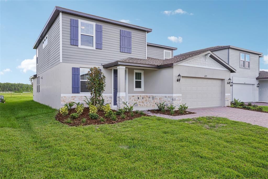 4519 Windy Oak Way St. Cloud, FL 34772 - Photo 3 of 40 a front view of house with a garden