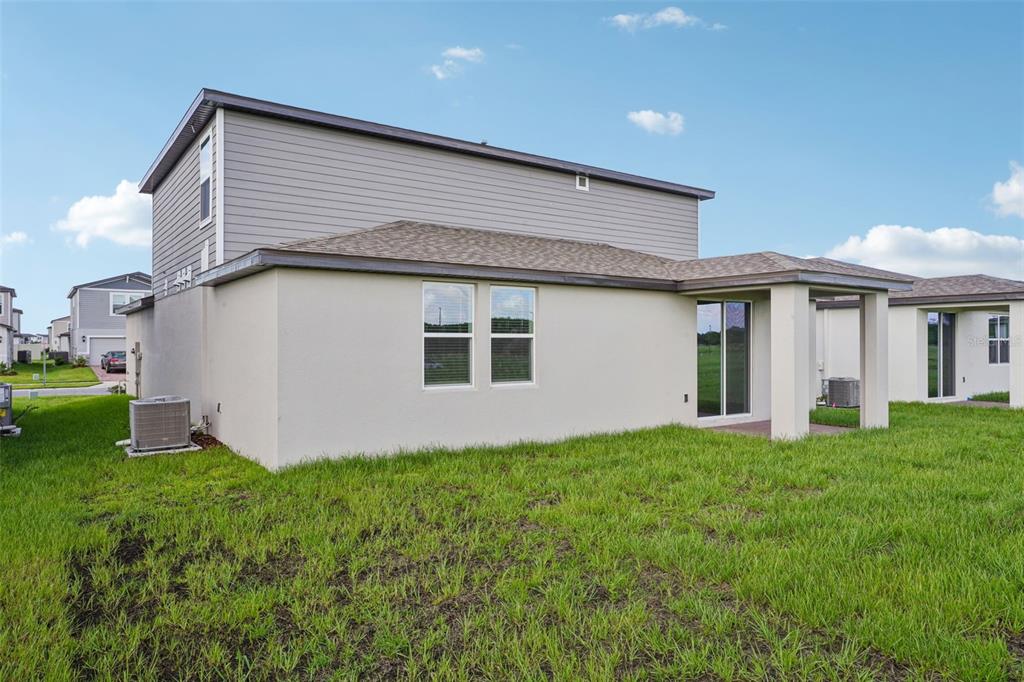 4519 Windy Oak Way St. Cloud, FL 34772 - Photo 36 of 40 a house with garden in front of it