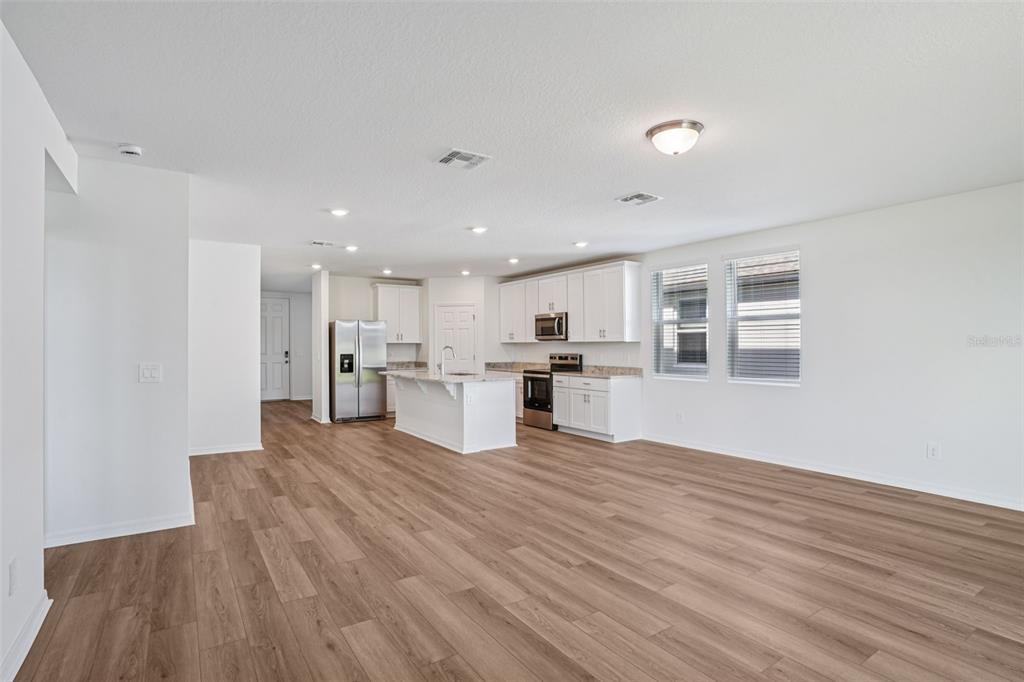 4519 Windy Oak Way St. Cloud, FL 34772 - Photo 8 of 40 a view of kitchen dining table chairs microwave and cabinets