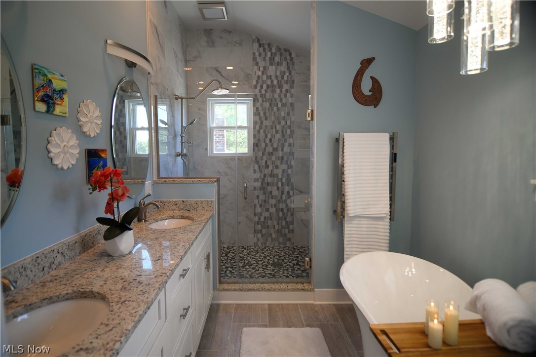4540 Ridge Road Medina, OH 44256 - Photo 25 of 49 En Suite Main Bathroom with elegant lighting, dual shower head tiled shower space, double sinks and custom cabinetry.
