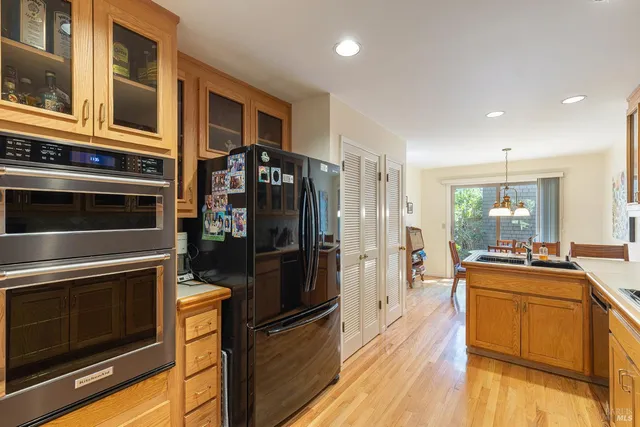 a kitchen with stainless steel appliances a stove a refrigerator and a microwave