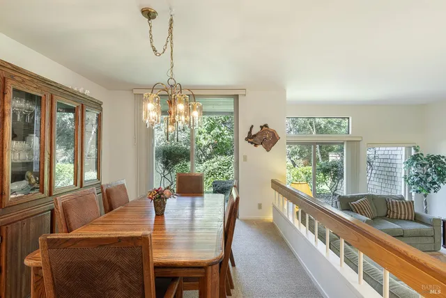 a dining room with furniture a chandelier and window