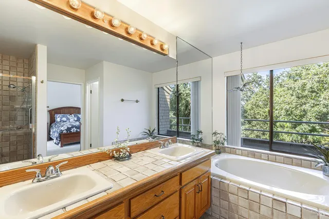 a bath tub sitting next to a bathroom sink and a bath tub