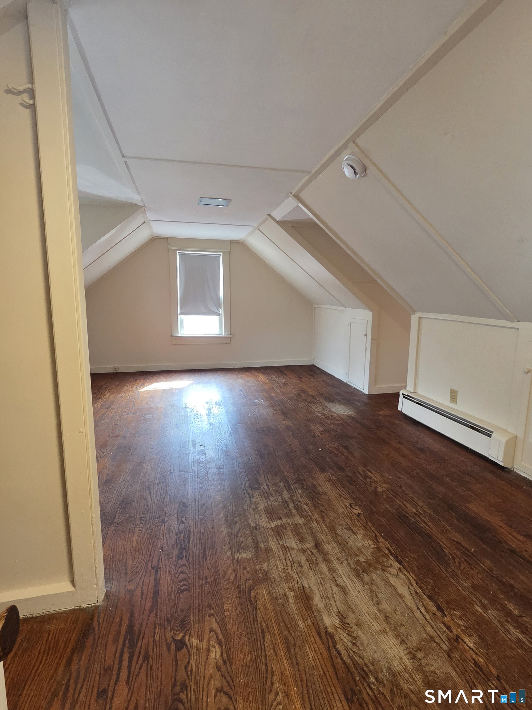 397 Buddington Road Groton, CT 06340 - Photo 11 of 13 an empty room with wooden floor and windows