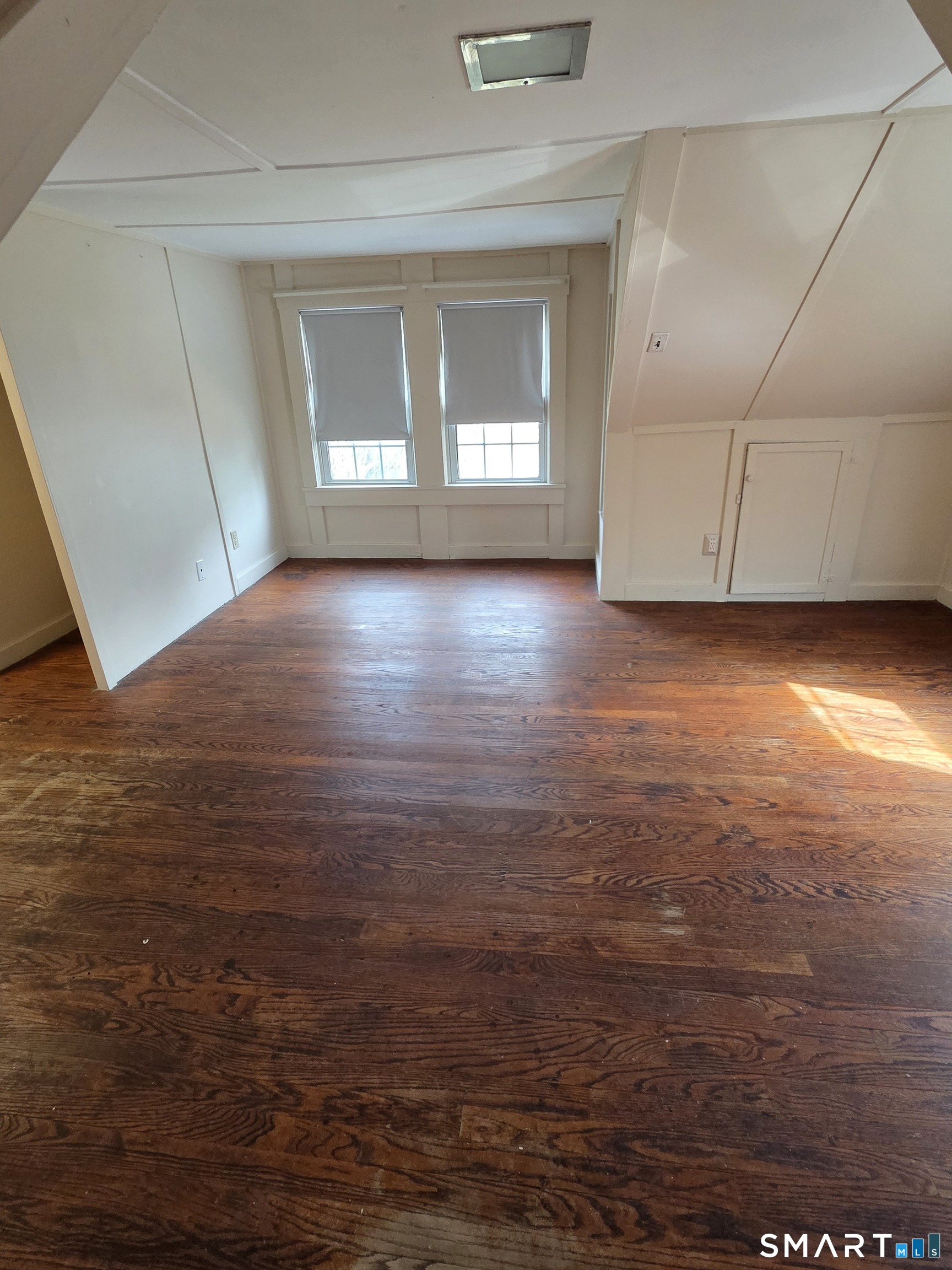 397 Buddington Road Groton, CT 06340 - Photo 13 of 13 an empty room with wooden floor and windows