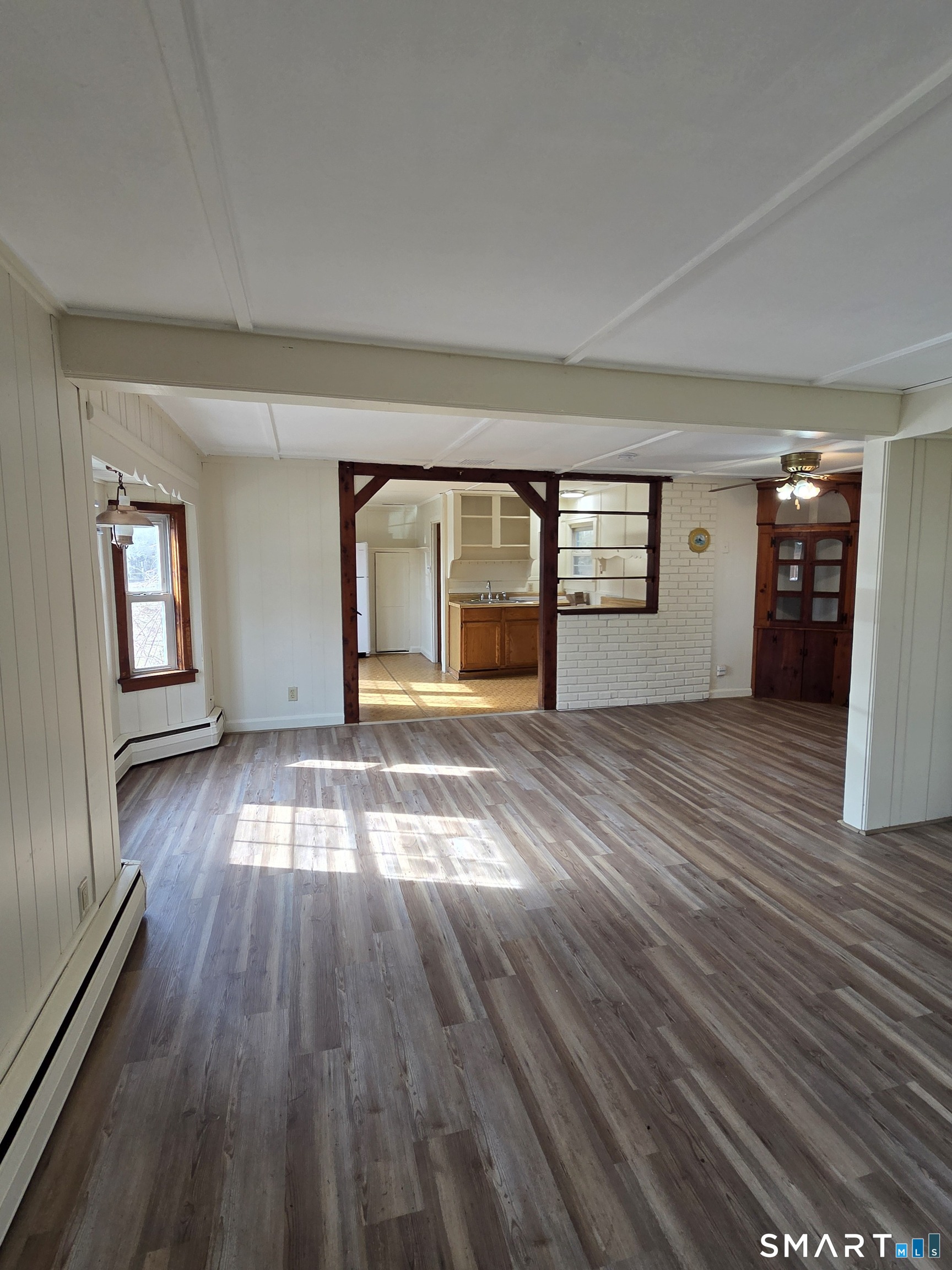 397 Buddington Road Groton, CT 06340 - Photo 5 of 13 wooden floor in an empty room with a window