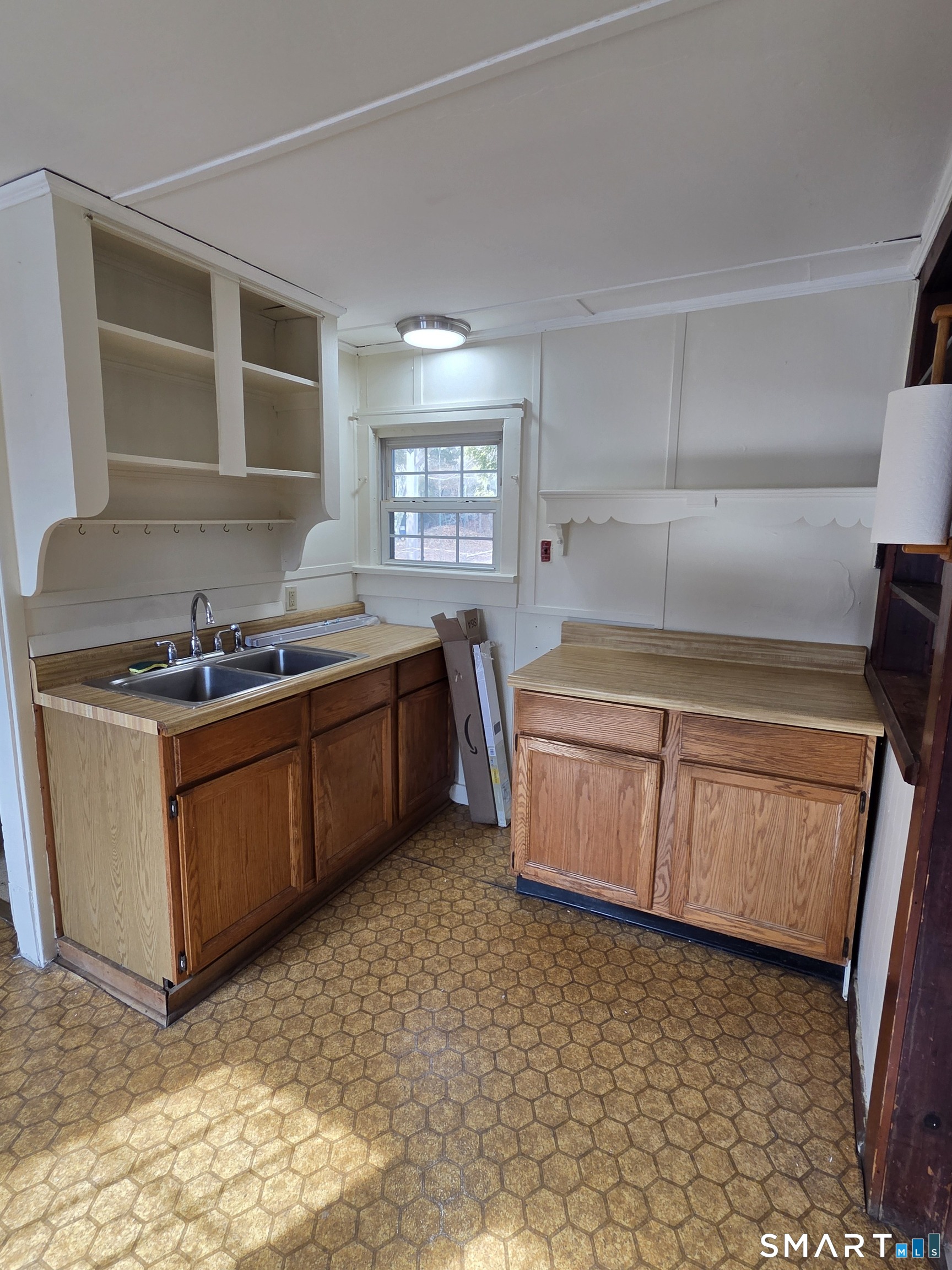 397 Buddington Road Groton, CT 06340 - Photo 7 of 13 a kitchen with a sink a stove cabinets and a window