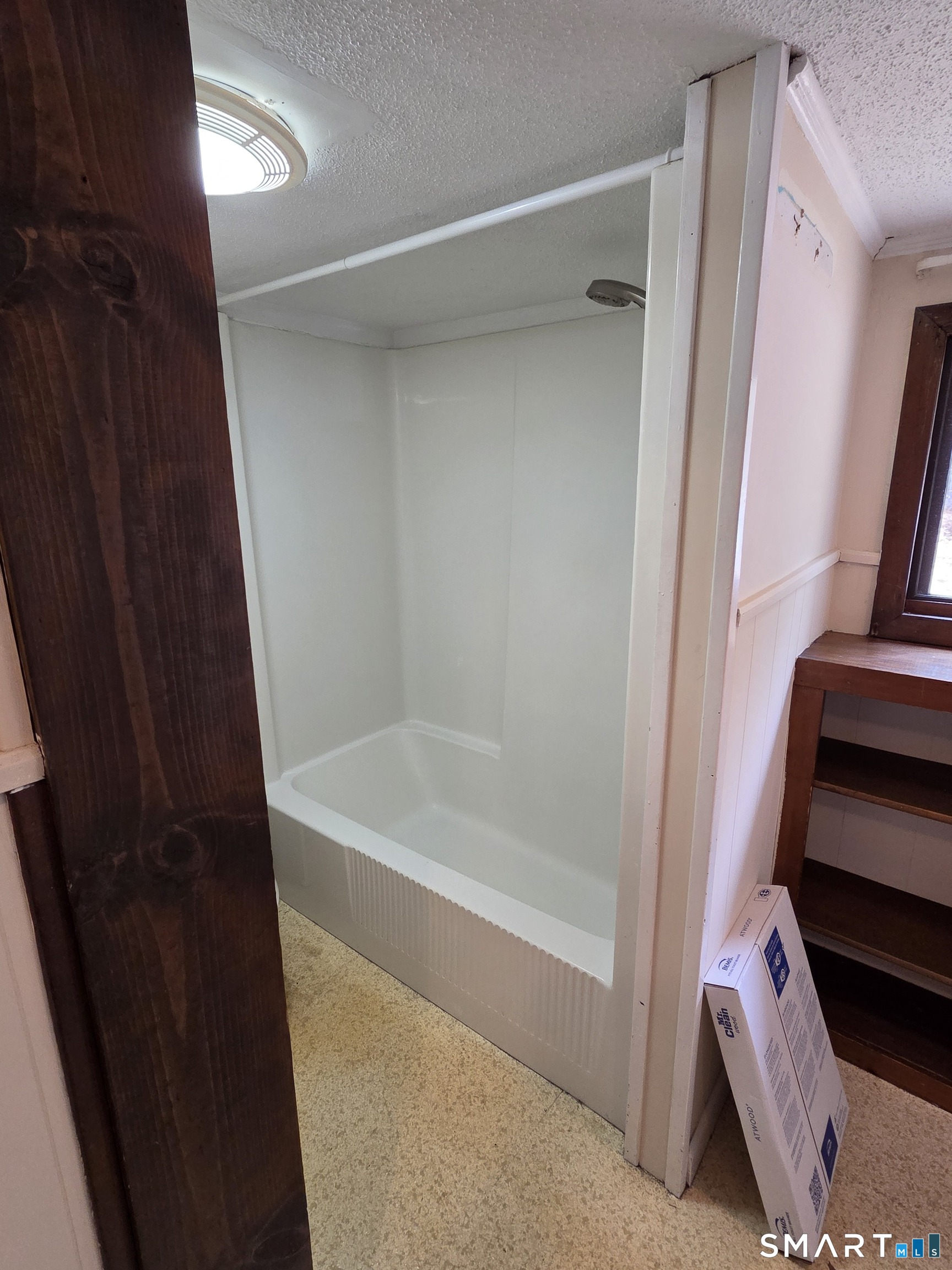 397 Buddington Road Groton, CT 06340 - Photo 10 of 13 a bathroom with a bathtub and a shower