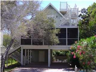 a view of a house with a yard and potted plants