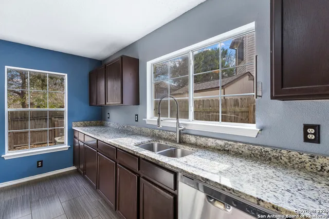 a kitchen with granite countertop a sink and a window