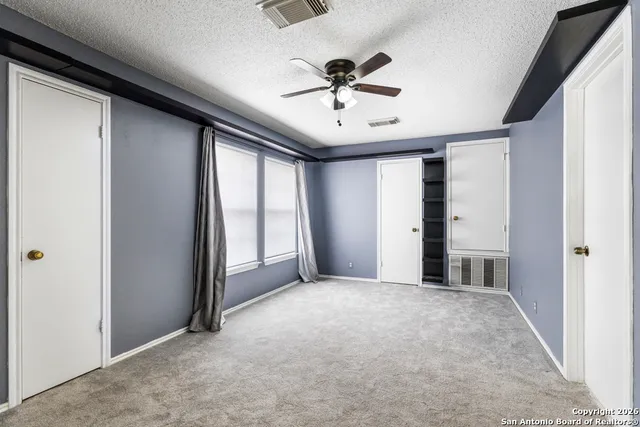 a view of a livingroom with a ceiling fan and window