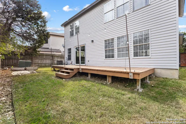 a backyard of a house with table and chairs