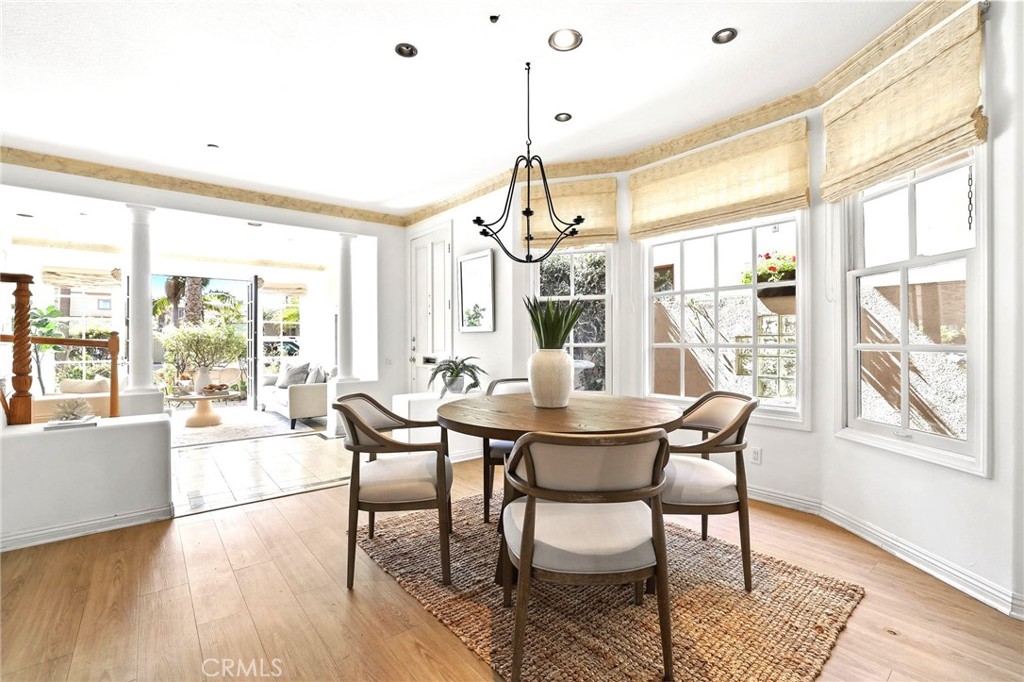 247 6th Street Seal Beach, CA 90740 - Photo 11 of 39 a view of a dining room with furniture large windows and wooden floor