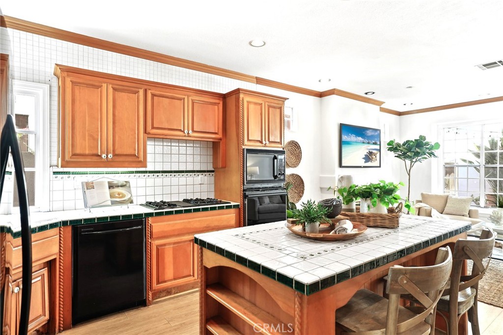 247 6th Street Seal Beach, CA 90740 - Photo 12 of 39 a kitchen with a stove a sink and a refrigerator