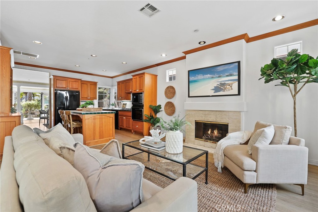 247 6th Street Seal Beach, CA 90740 - Photo 15 of 39 a living room with furniture potted plant and a fireplace