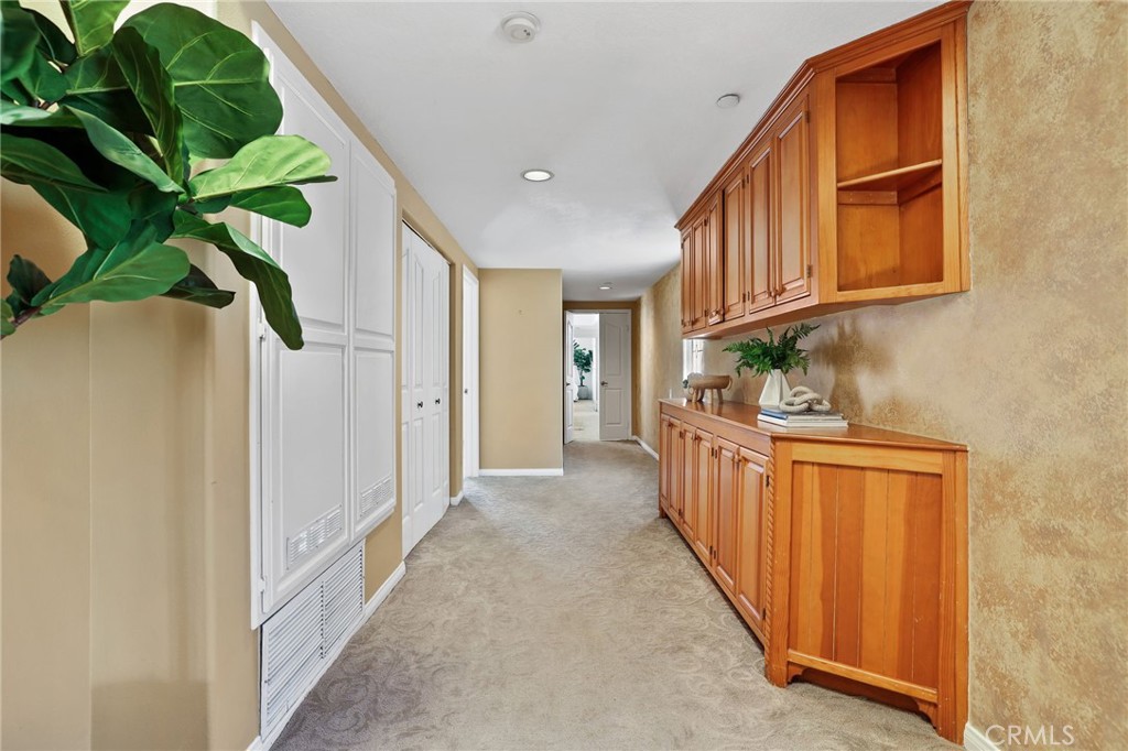 247 6th Street Seal Beach, CA 90740 - Photo 18 of 39 a hallway with stainless steel appliances granite countertop a stove a sink and a refrigerator