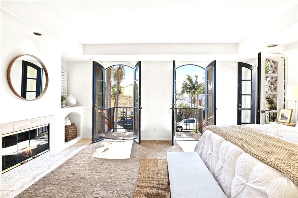 247 6th Street Seal Beach, CA 90740 - Photo 21 of 39 a bedroom with a large bed and a large window