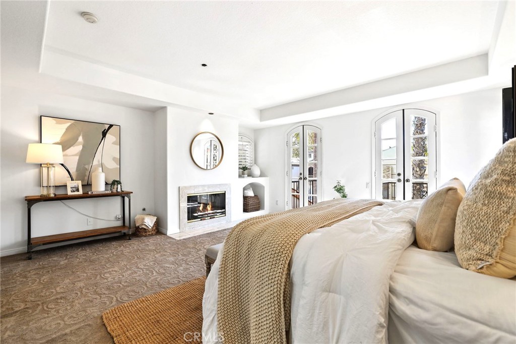 247 6th Street Seal Beach, CA 90740 - Photo 22 of 39 a spacious bedroom with a bed a dresser and mirror