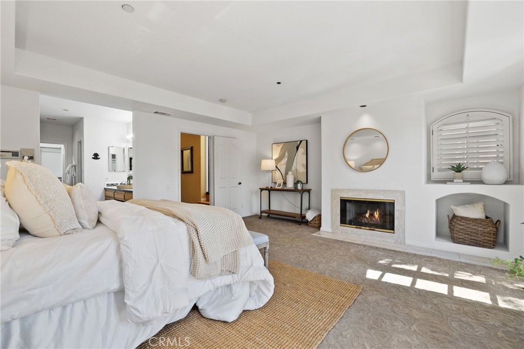247 6th Street Seal Beach, CA 90740 - Photo 24 of 39 a bed room with a bed and fireplace