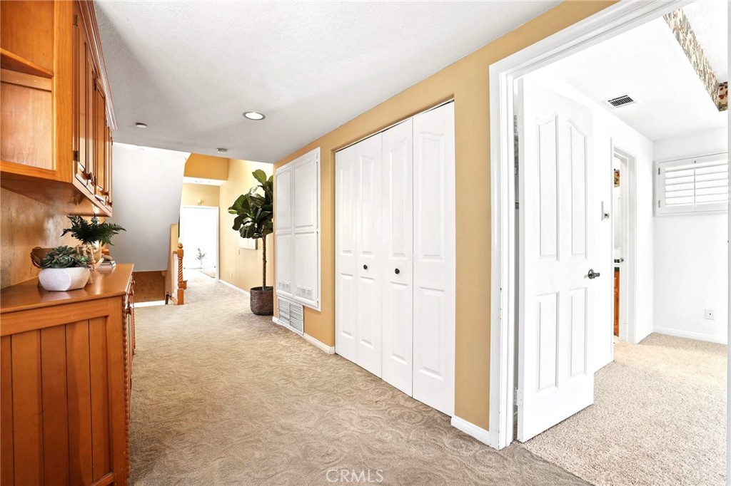 247 6th Street Seal Beach, CA 90740 - Photo 27 of 39 a view of a hallway with dining area and chandelier