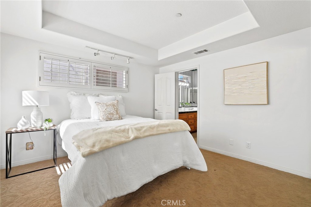 247 6th Street Seal Beach, CA 90740 - Photo 31 of 39 a bedroom with a bed and wooden floor