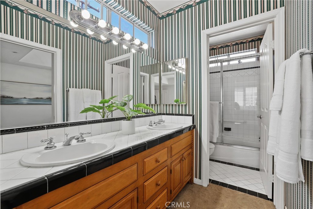 247 6th Street Seal Beach, CA 90740 - Photo 32 of 39 a bathroom with a sink and a mirror