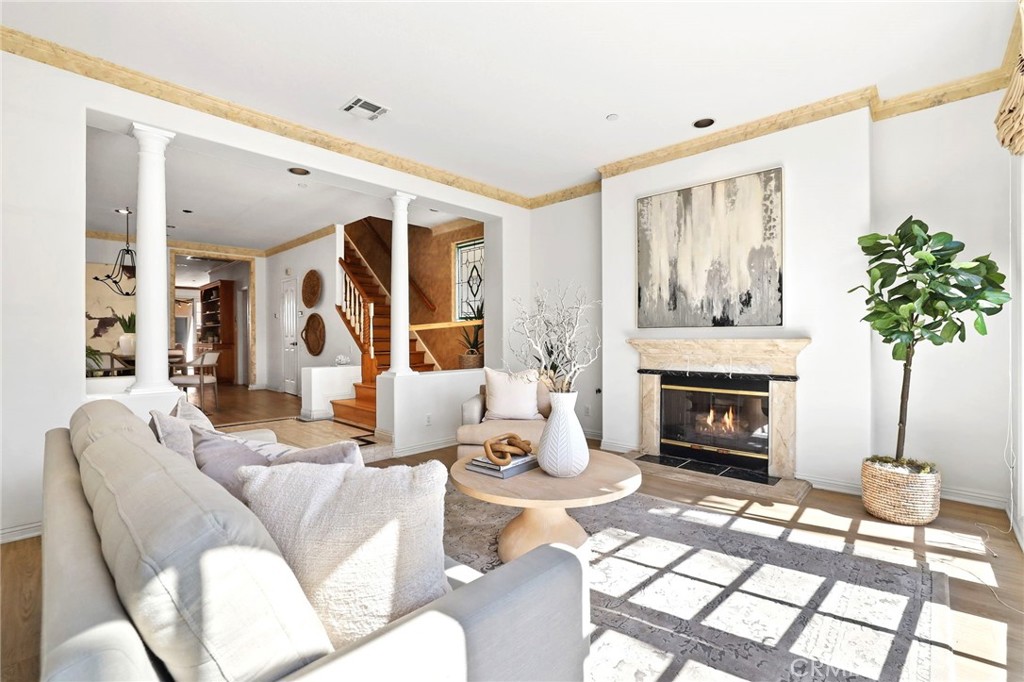 247 6th Street Seal Beach, CA 90740 - Photo 7 of 39 a living room with furniture a potted plant and a fireplace