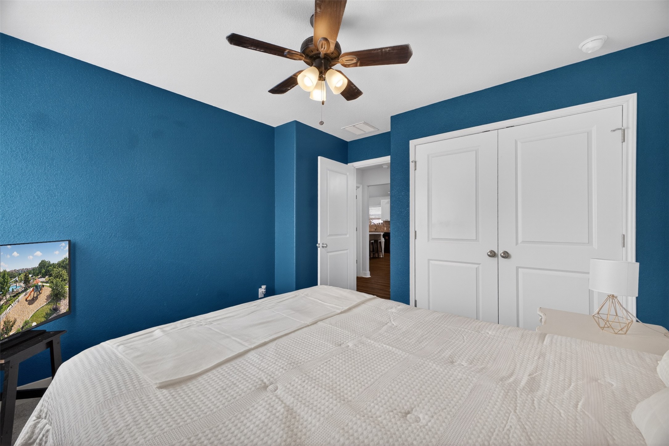 1009 Bright Star Cove Georgetown, TX 78628 - Photo 23 of 40 a bedroom with a bed and a chandelier