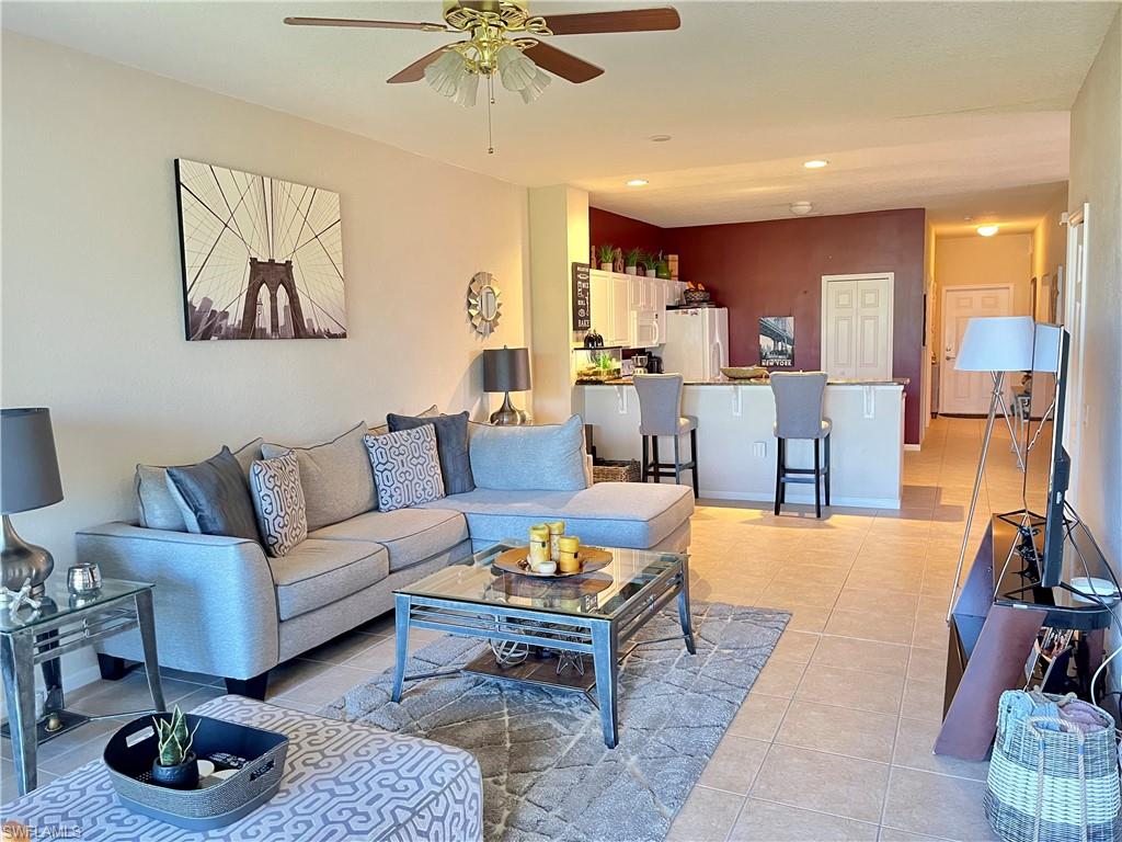 10045 Heather Lane, Unit 2203 Naples, FL 34119 - Photo 1 of 23 a living room with furniture a rug and a chandelier