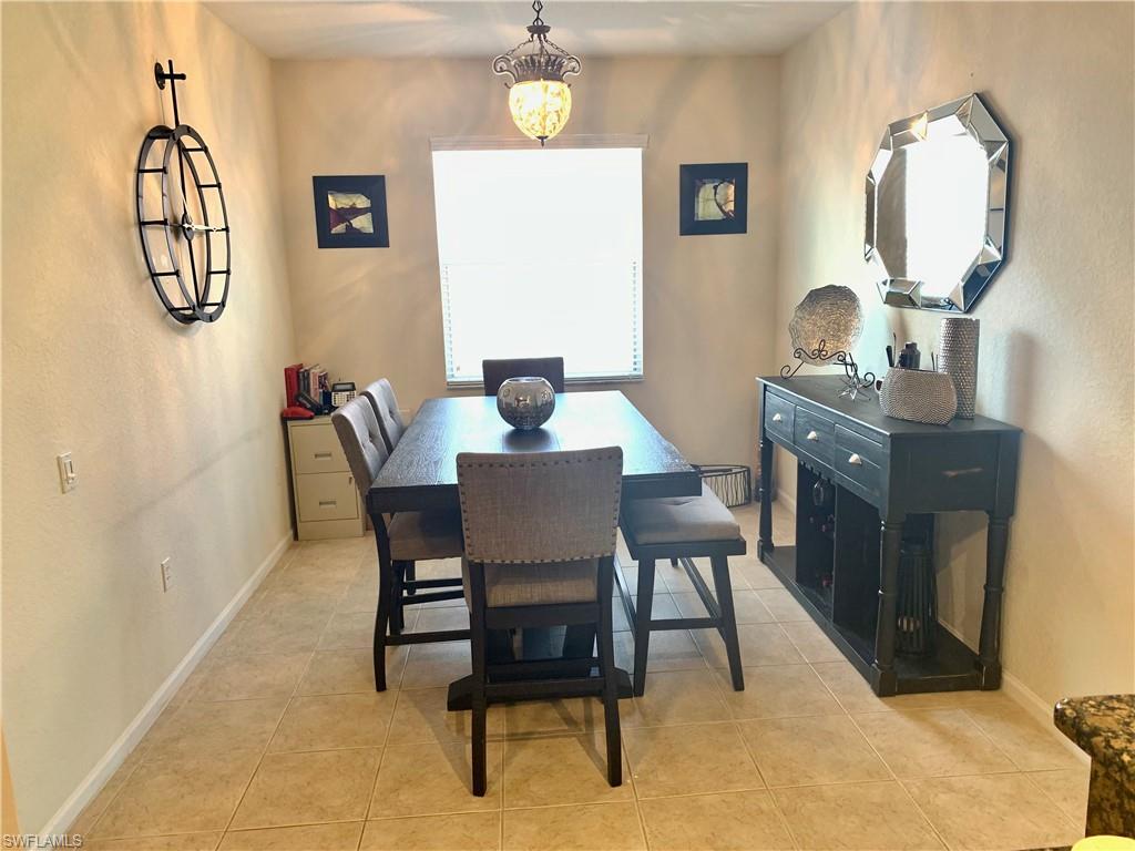 10045 Heather Lane, Unit 2203 Naples, FL 34119 - Photo 4 of 23 a view of a dining room with furniture