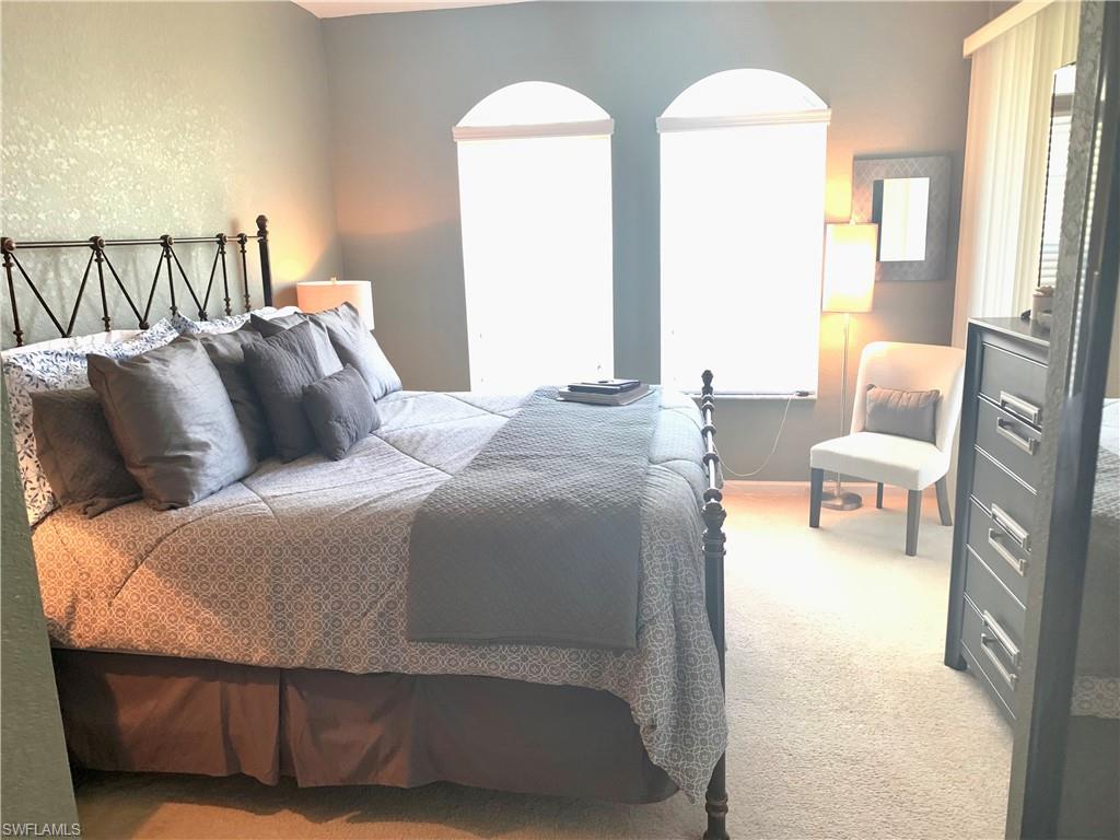 10045 Heather Lane, Unit 2203 Naples, FL 34119 - Photo 6 of 23 a bedroom with bed and window