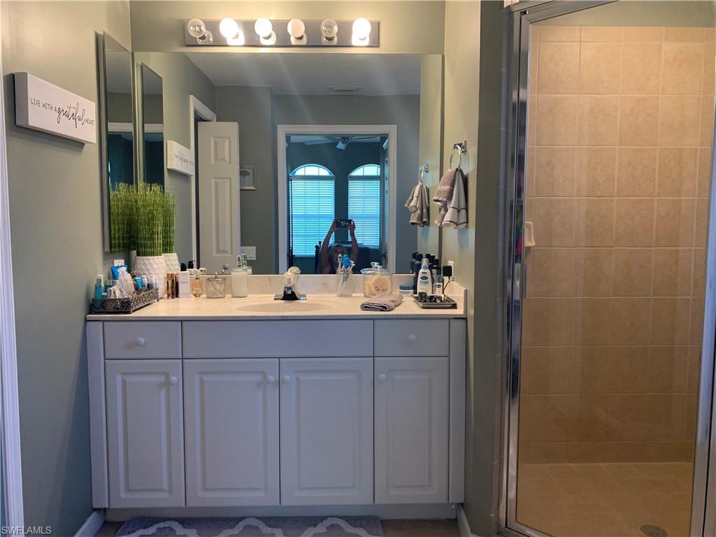 10045 Heather Lane, Unit 2203 Naples, FL 34119 - Photo 7 of 23 a bathroom with a sink and a mirror