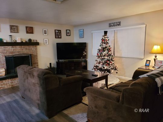 120 South Fire Opal Street Ridgecrest, CA 93555 - Photo 8 of 17 a living room with furniture a flat screen tv and a fireplace