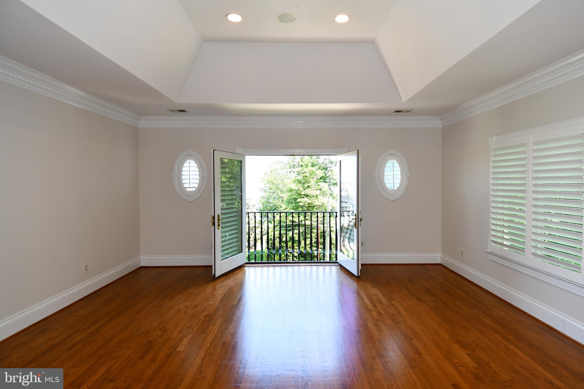 7808 Southdown Road Alexandria, VA 22308 - Photo 61 of 99 an empty room with wooden floor and windows