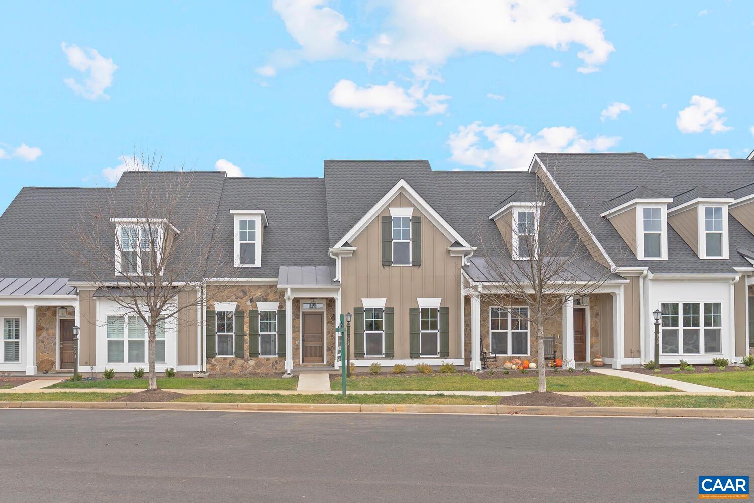 a front view of a residential apartment building with a yard