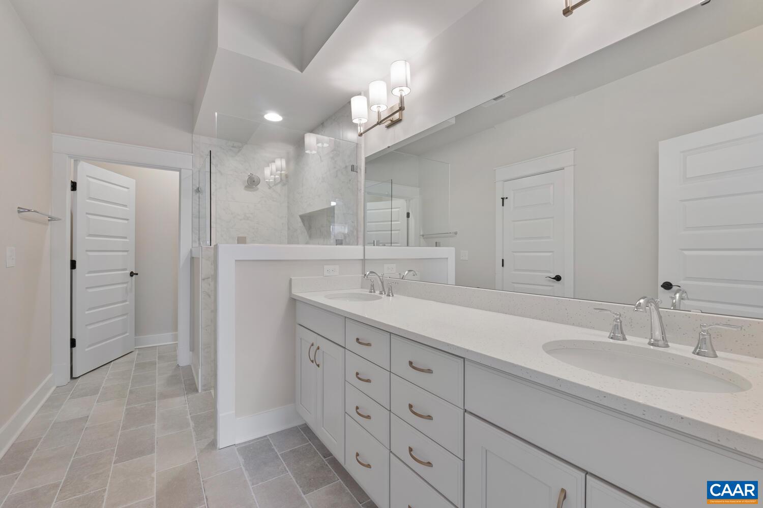 935 Addle Hill Road Crozet, VA 22932 - Photo 15 of 56 a bathroom with a double vanity sink and a mirror