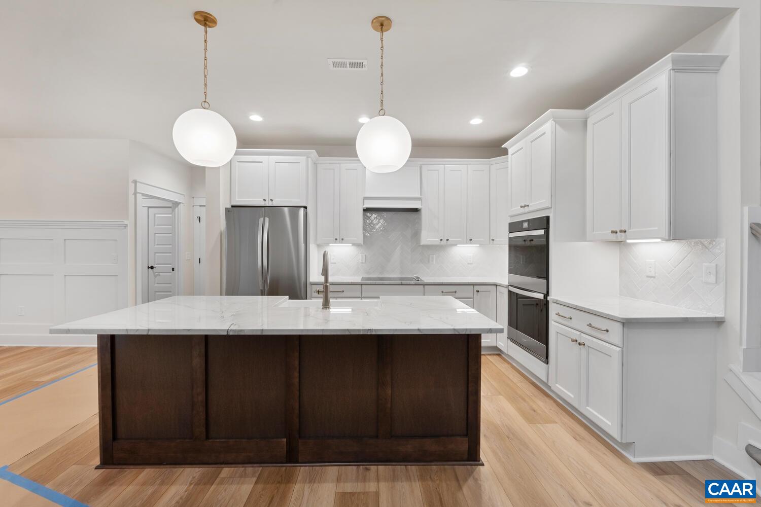 935 Addle Hill Road Crozet, VA 22932 - Photo 23 of 56 a kitchen with kitchen island granite countertop a sink cabinets and stainless steel appliances