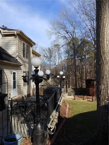 a view of a house with backyard and sitting area