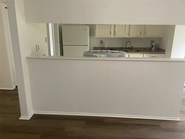 a kitchen with a sink a stove and cabinets
