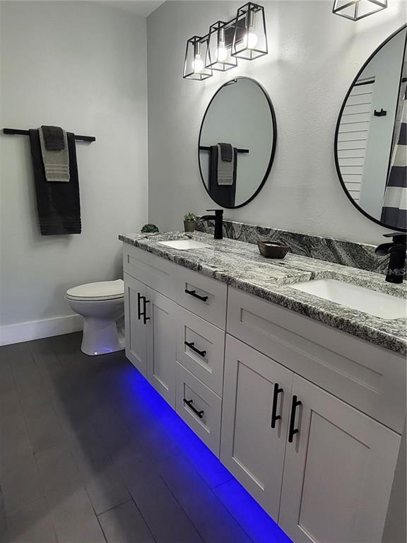 1801 East Lake Road South, Unit 15E Palm Harbor, FL 34685 - Photo 13 of 24 a bathroom with 2 sink and a mirror