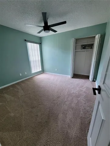 a view of a livingroom with a ceiling fan and window