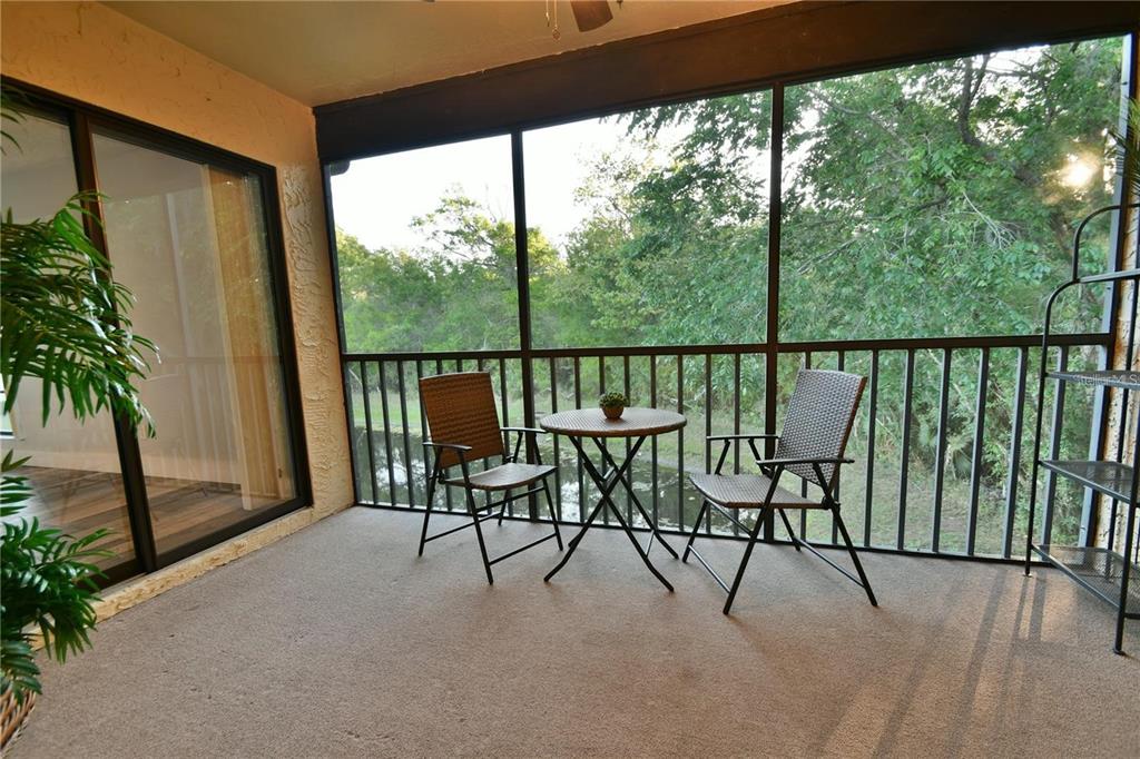 1801 East Lake Road South, Unit 15E Palm Harbor, FL 34685 - Photo 18 of 24 a view of a two chair in the balcony