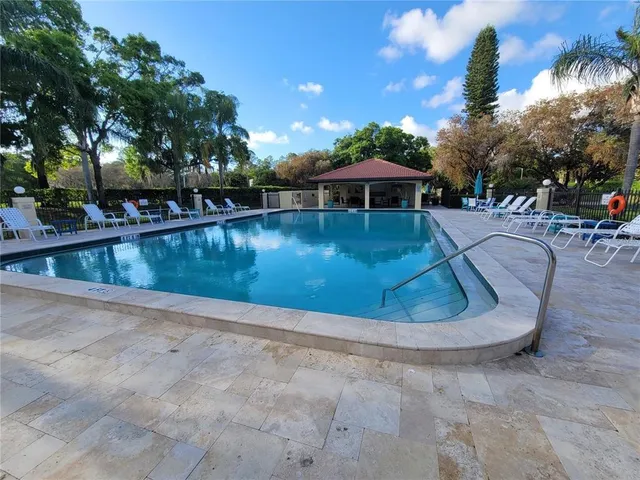 a view of a swimming pool with a patio