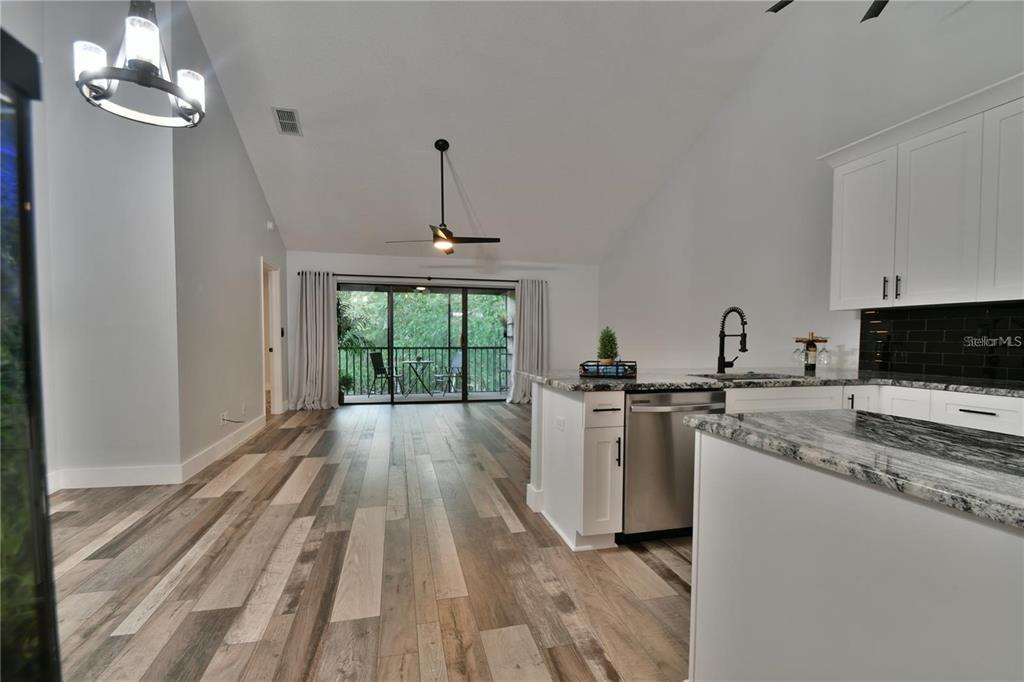 1801 East Lake Road South, Unit 15E Palm Harbor, FL 34685 - Photo 3 of 24 a kitchen with a stove a sink and a refrigerator