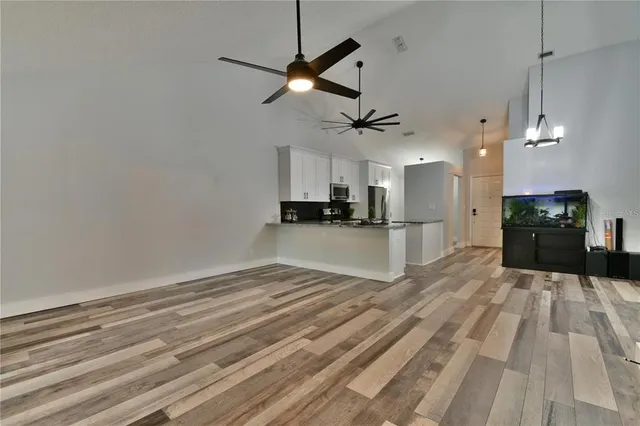 a view of a kitchen with a dishwasher and wooden floor