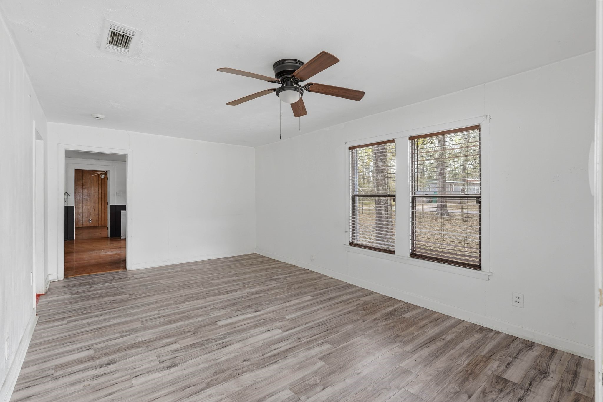 3110 Green Forest Road Conroe, TX 77303 - Photo 38 of 50 a view of empty room with wooden floor and ceiling fan